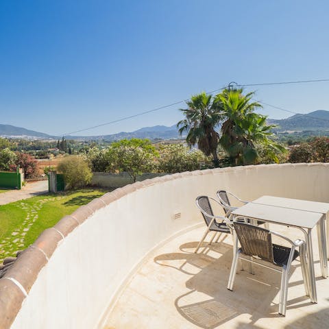 Watch the sun dip behind the undulating landscape on the balcony