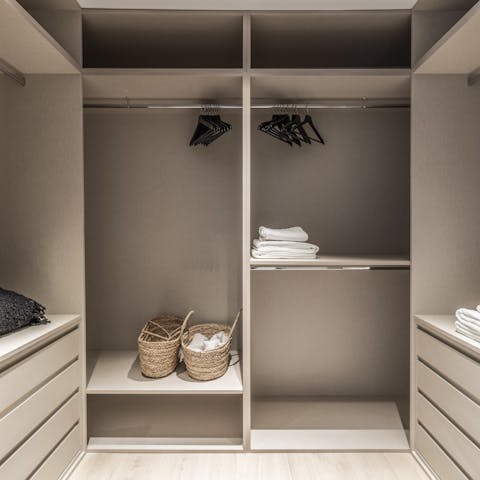 Place an outfit for every occasion in the main bedroom's walk-in wardrobe