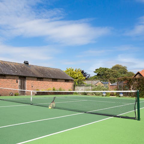 Enjoy a game of tennis with loved ones on the communal court