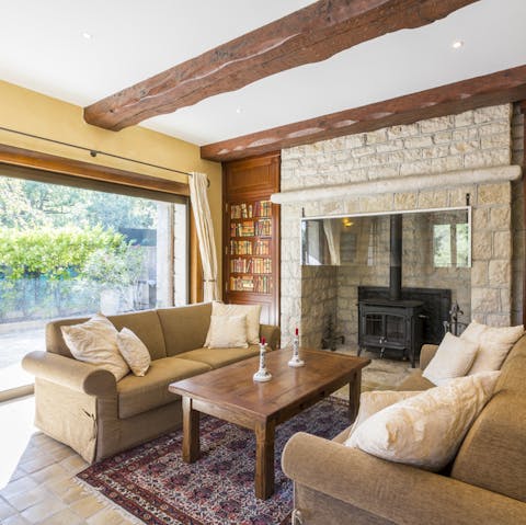 Enjoy a little R&R in this cosy lounge, where you'll find one of the home's two wood-burning stoves