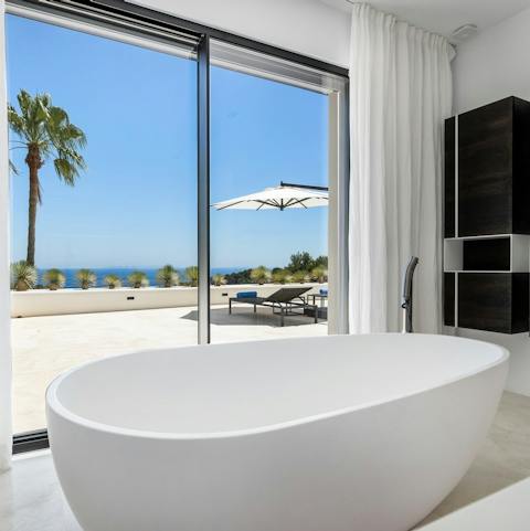 Treat yourself to a glass of wine and a long soak in the freestanding bathtub