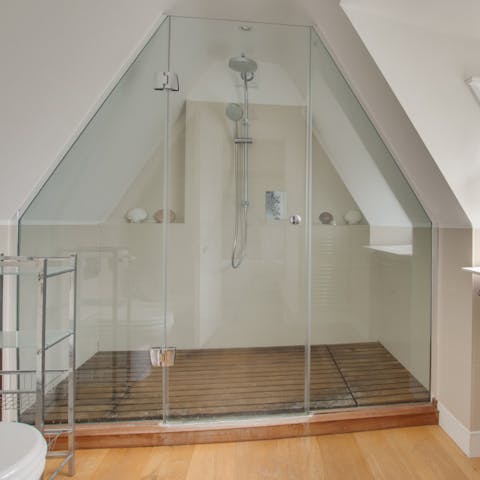 Freshen up in the huge shower in the uniquely-shaped bathroom