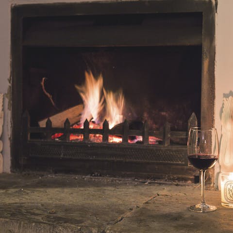 Relax by the fireplace with a good book and a glass of wine