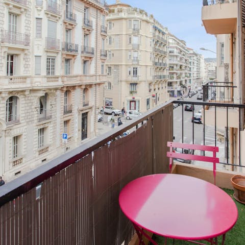 Enjoy a nice glass of wine on your balcony as you watch the world go by