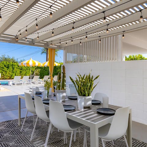 Dine alfresco beneath the twinkling lights of the pergola 