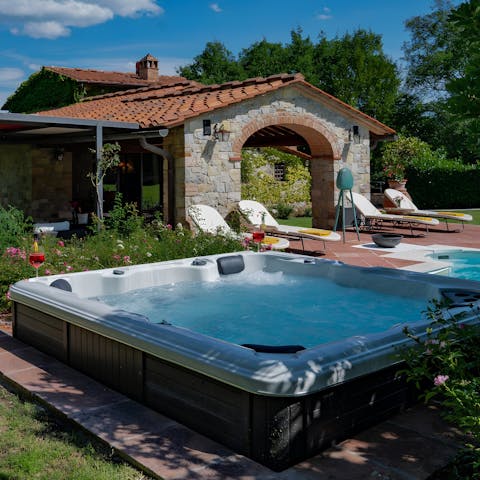 Sink into the heated hot tub with a glass of wine