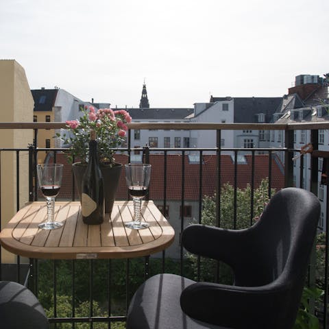 Sip sundowners on your private balcony while enjoying views of Christiansborg’s spire 