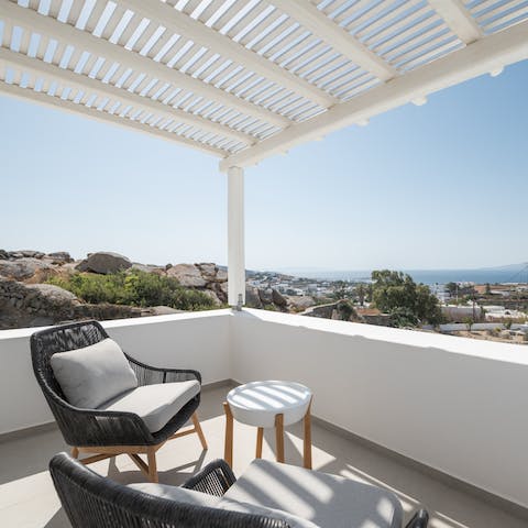 Gaze out at the Aegean Sea from your shaded balcony