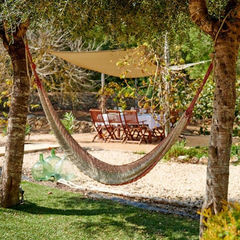 Enjoy a siesta in the hammock shaded by the olive trees