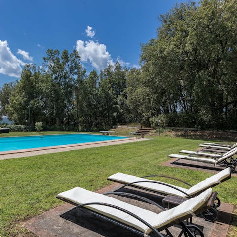 Relax on a lounger overlooking the private pool