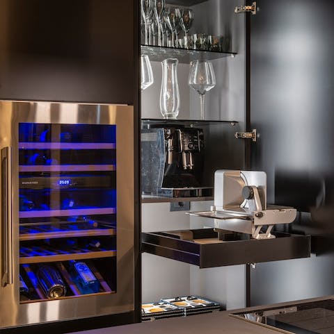 Select a bottle from the wine fridge or discover the concealed coffee machine in the stylish kitchen