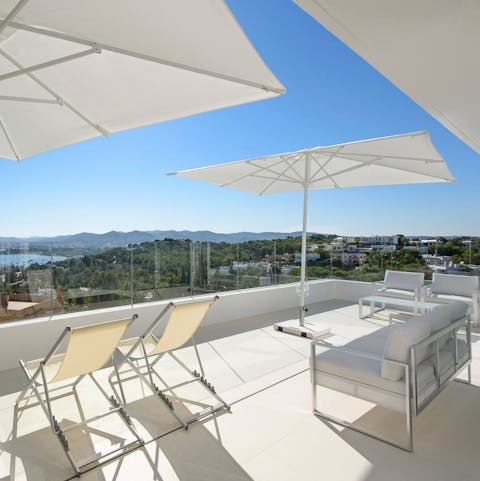 Enjoy panoramic views of Ibiza's coastline from the rooftop terrace
