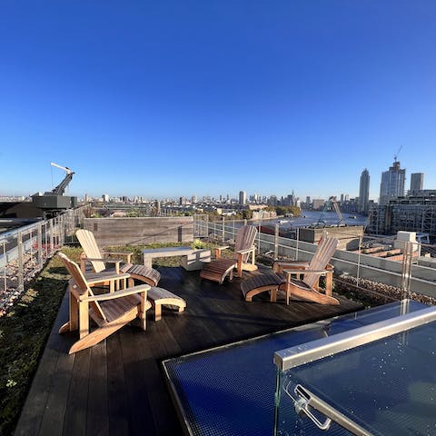 Share drinks on the rooftop terrace as the sun sets over the city