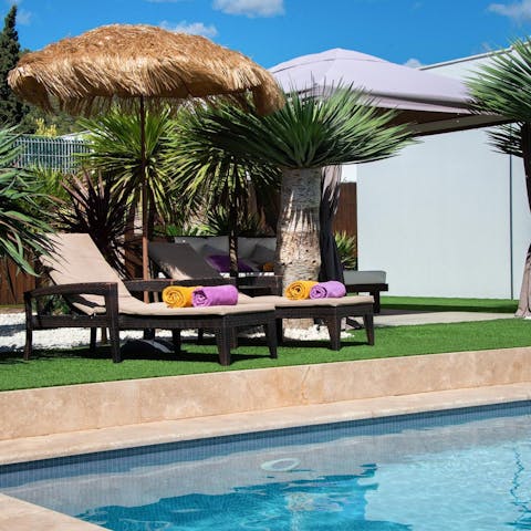 Rest on a lounger by the private outdoor pool with a cocktail in hand