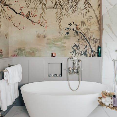 Soak the day away in the tub beneath the Japanese wallpaper