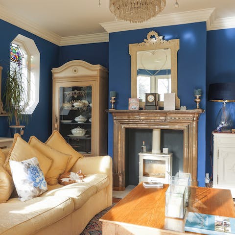 Relax by the wood-burner in the daring midnight-blue lounge