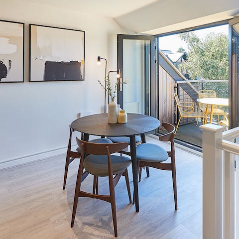 Gather around the chic, mid-century-style dining table for a relaxed meal at home