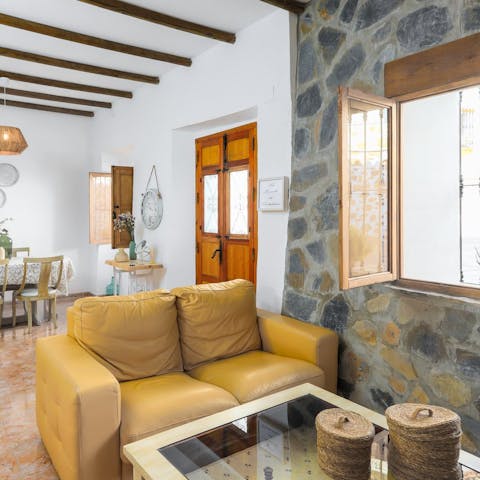 Cosy up in the characterful living area and admire the traditional stone walls and wooden beams