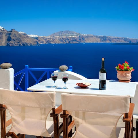 Sit down to a romantic alfresco meal overlooking the Aegean Sea