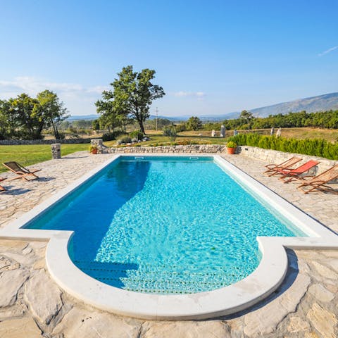 Enjoy expansive countryside views whilst relaxing by the pool