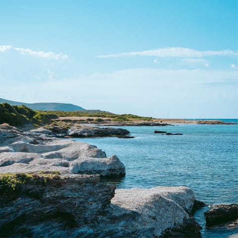 Bask in the sunshine on Arinella Bianca Beach, a twelve-minute drive away