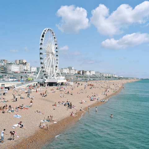 Soak up the lively atmosphere at Brighton beach, an easy drive away