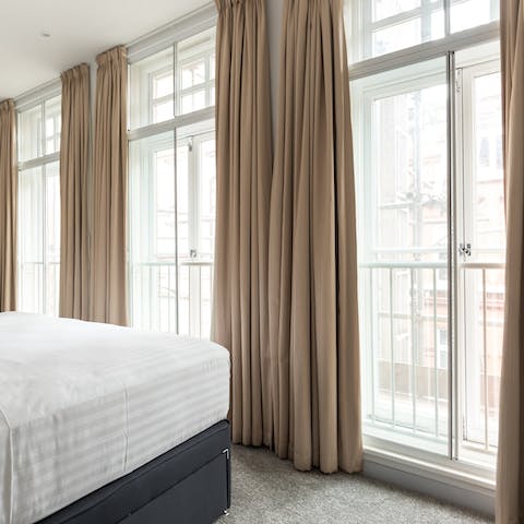 Enjoy natural light streaming into the bedroom through three huge windows