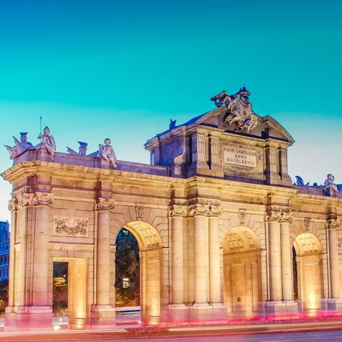 Visit the Neoclassical gate of Puerta de Alcalá, a direct bus ride or good walk away