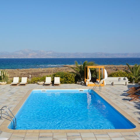 Take a dip in the communal pool as you look out to sea views
