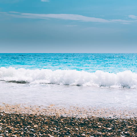 Let the sea wash over your feet at Petalidi beach, a short drive away