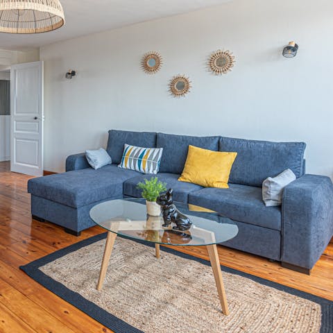 Kick back and relax on the comfy sofa in the bright living room 