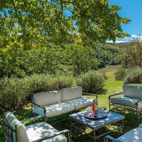 Relax under the trees while sipping on an Italian aperitif 