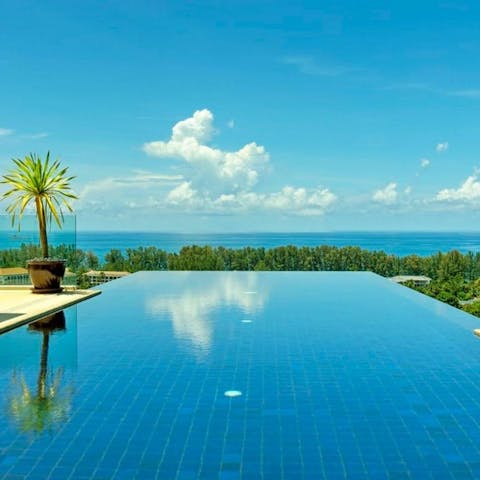 Take a dip in your infinity pool, overlooking the lush tropical greenery and Pacific Ocean