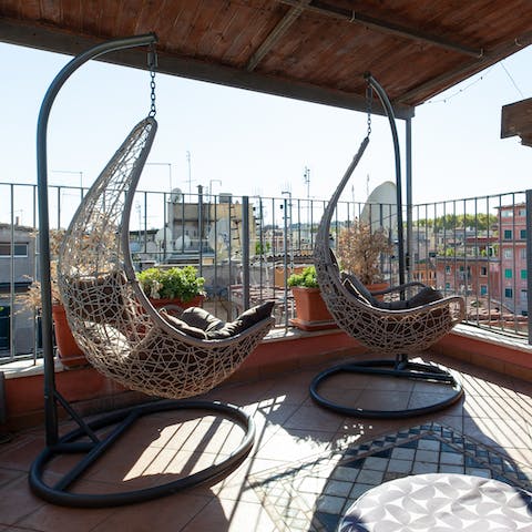 Chill out in the hanging chairs overlooking Rome's rooftops
