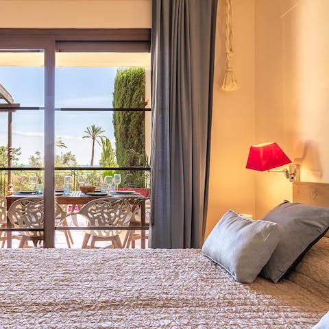 Wake up to swaying palm trees from the main bedroom