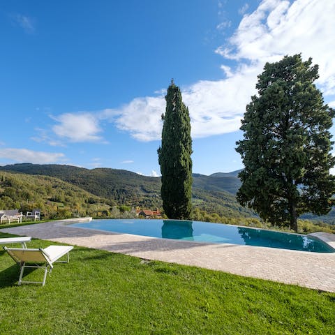 Cool off in the infinity pool with a view of the Tuscan hills