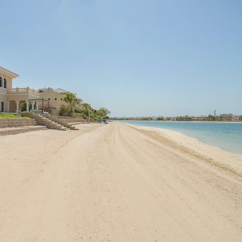 Pad down the stone steps to the soft sand of the private beach