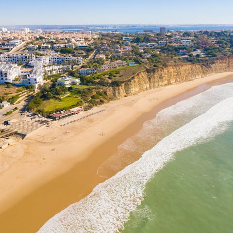 Take a breezy stroll down to Meia Praia and paddle in the sea