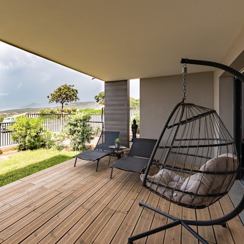 Take a moment to yourself to relax in the swinging egg chair, catching up on your holiday read