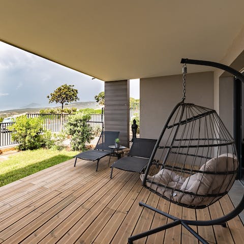 Take a moment to yourself to relax in the swinging egg chair, catching up on your holiday read