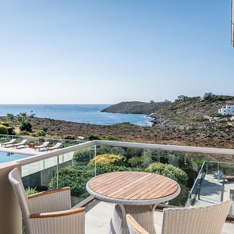 Start your day with coffee on the secluded balcony that overlooks the garden and sparkling seascape