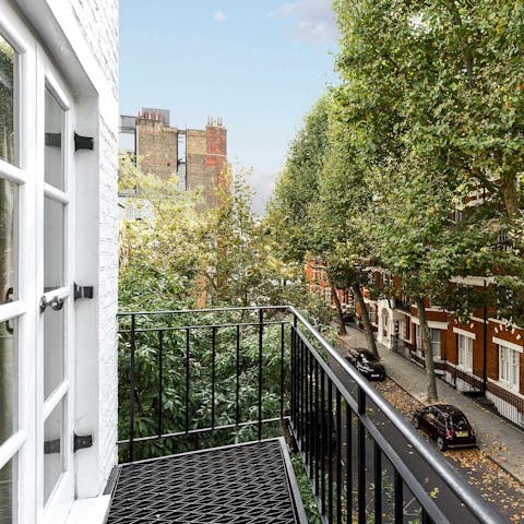 Peer out over Kensington's leafy streets from the private balcony