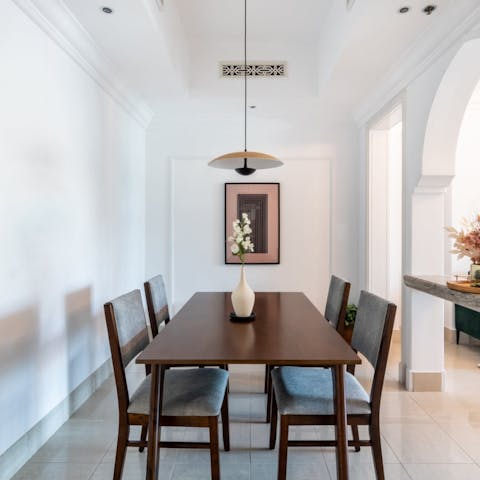 Gather around the traditional dining table for home-cooked family meals, the low-hanging light setting the ambience