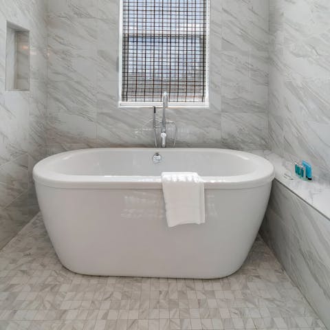 Slope away for a soak in the freestanding bathtub