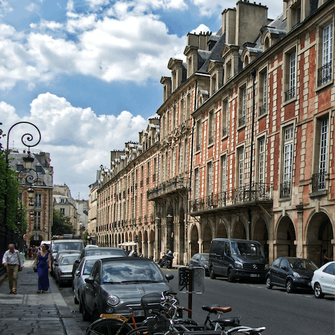 Plan a picnic at the historic Place des Vosges, an eight-minute walk away