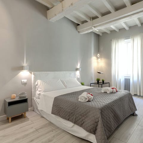 Have a rest in the bedroom with its calming grey hues after a wine tasting trip