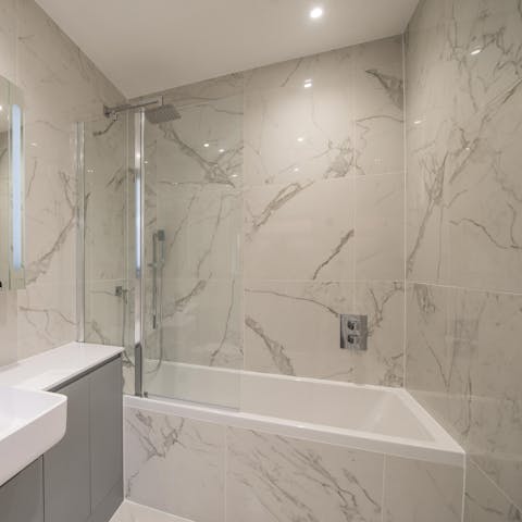 End your evening with a long soak in the marble-clad tub