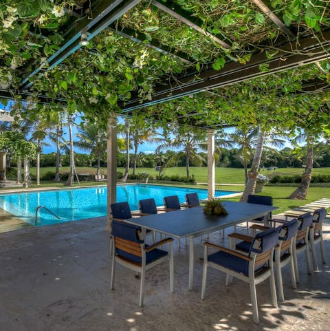 Dine beside the pool beneath a beautiful canopied pergola