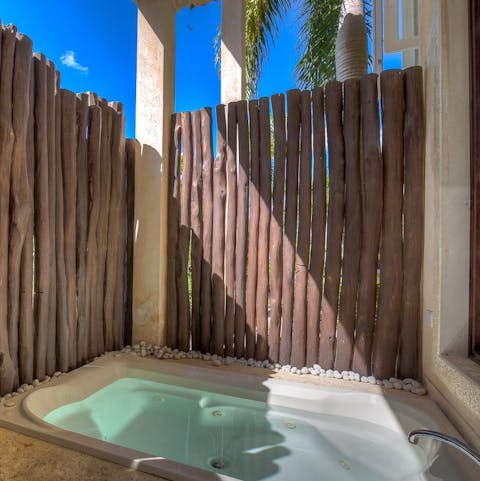 Relax in your private jacuzzi and watch the clouds float by