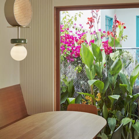 Admire the home's tropical gardens – huge windows allow the indoors and outdoors to merge